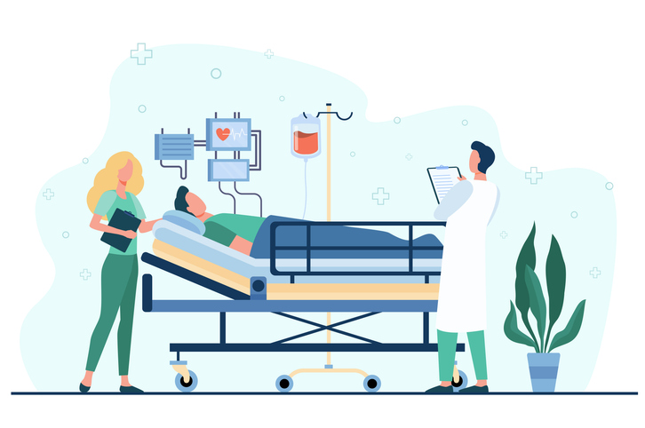 Doctor and nurse giving medical care to patient in bed